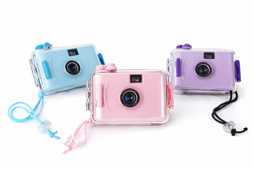 Three colorful disposable cameras with lanyards on a white background